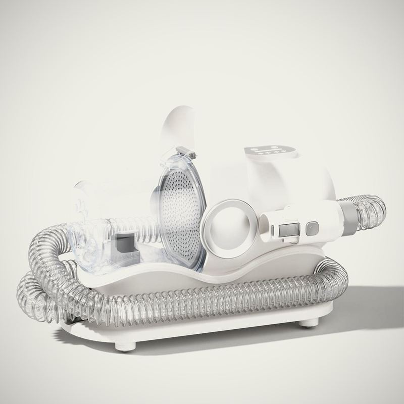 The Grooming Vacuum, Complete. The same unit with the full attachment set and a stand.